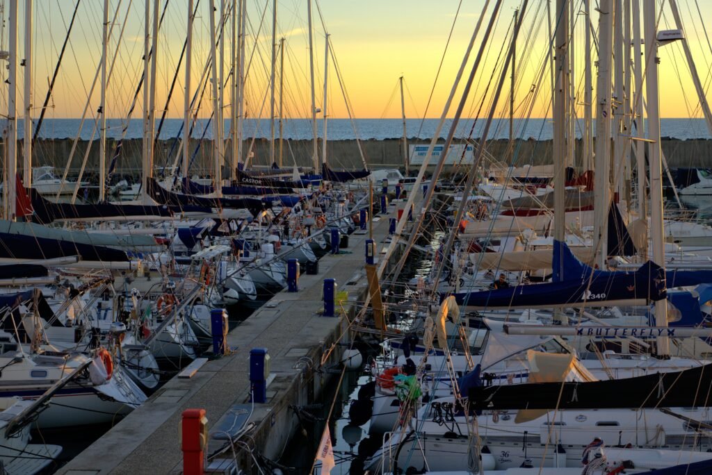 Scenic view of anchored boats at sunset in Lido di Ostia marina, Lazio, Italy.